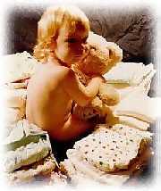 baby amidst a pile of cloth diapers